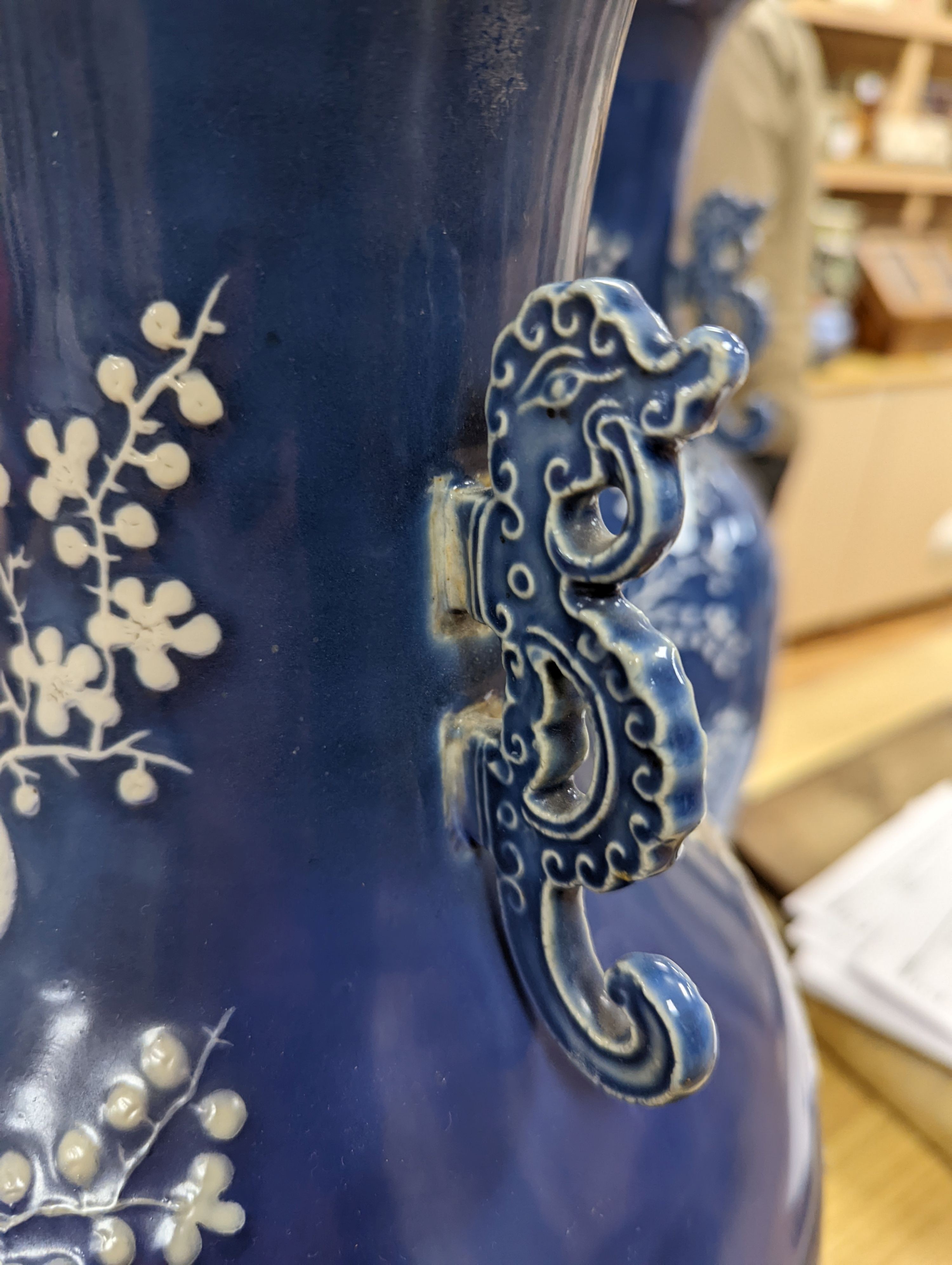 A pair of large 19th century Chinese slip decorated blue ground vases, restored, 59cm